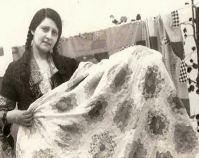 Historic photograph of a woman holding a Flower Garden quilt In upcoming book by Janet E. Finley, Schiffer Publishing,  Atglen, Pennsylvania; late 2012 Collection of Janet E. Finley