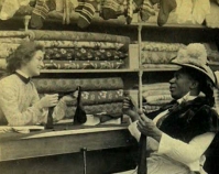 Historic photograph of a woman buying fabric Shelly Zegart Archives