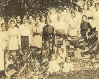 Historic photograph of group of people holding a quilt In upcoming book by Schiffer Publishing,  Atglen, Pennsylvania; late 2012 Collection of Janet E. Finley