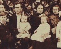 Historic photograph of a family of eight in front of a quilt  In upcoming book by Janet E. Finley Schiffer Publishing, Atglen, Pennsylvania; late 2012 Collection of Janet E. Finley