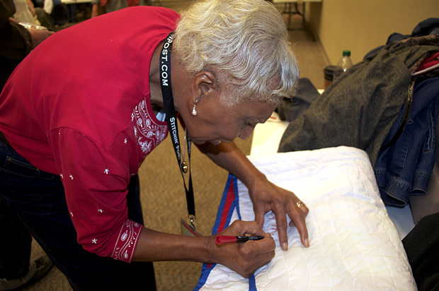 Lucy Mingo signing the "Bible Story" quilt, 2011